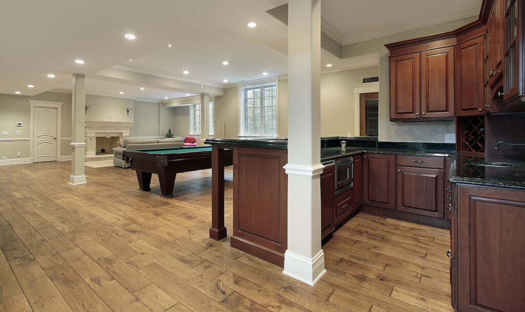 Basement in new construction home with bar and fireplace